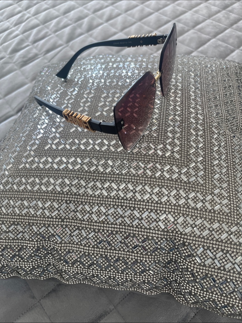 CHANEL Black Frames with Gold Trim and Burgundy Lenses Accent Pillow Display